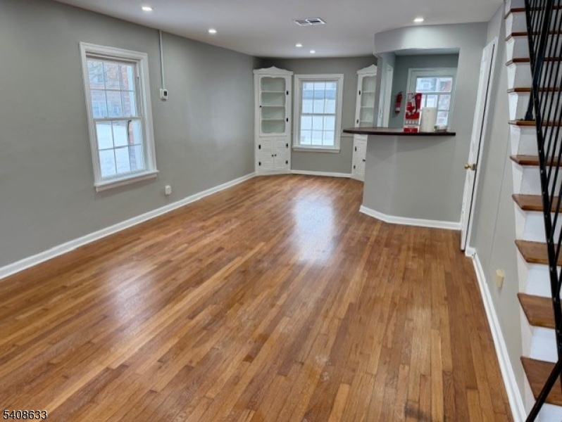 10 Beech Spring Drive, Unit 3A Summit, NJ 07901 - Photo 2 of 8 an empty room with wooden floor and windows