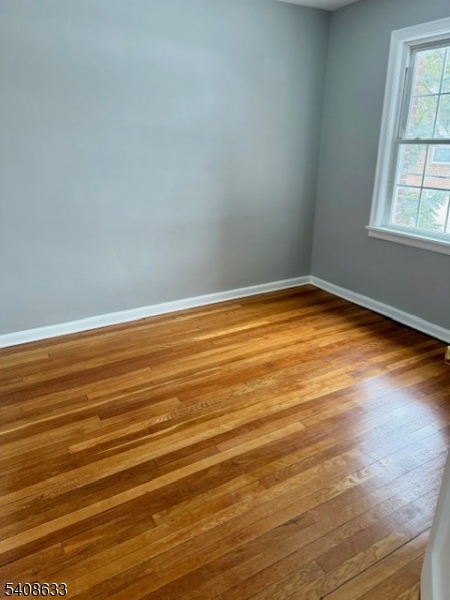 10 Beech Spring Drive, Unit 3A Summit, NJ 07901 - Photo 5 of 8 a view of empty room with wooden floor and fan