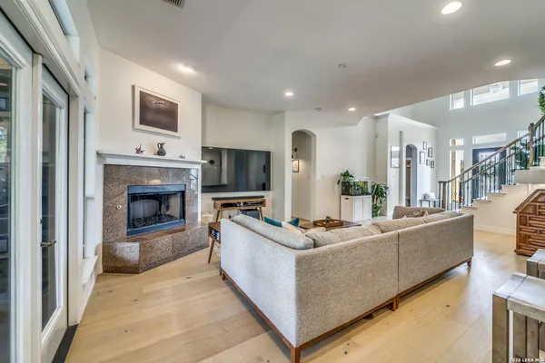 a living room with furniture a flat screen tv and a fireplace