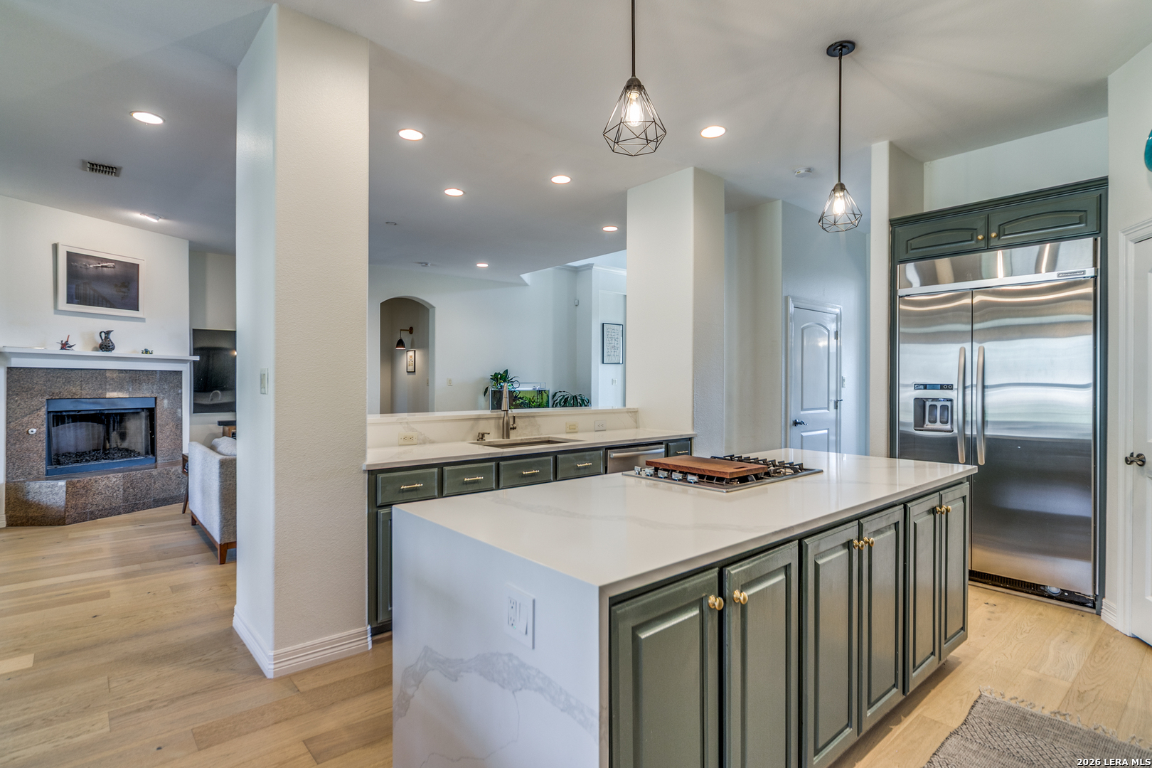 643 Ridge San Antonio, TX 78258 - Photo 20 of 45 a kitchen that has a lot of cabinets a sink and wooden floor