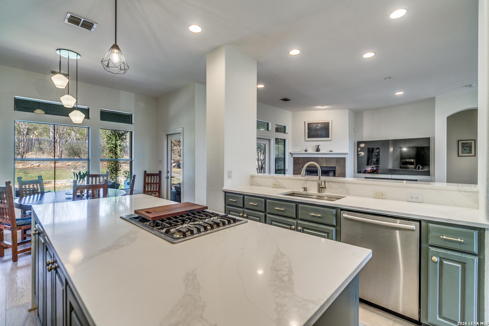 643 Ridge San Antonio, TX 78258 - Photo 21 of 45 a large kitchen with kitchen island a stove a sink a dining table and chairs