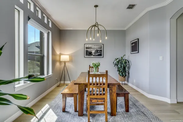 a view of a dining room with furniture and a chandelier