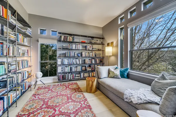 a living room with furniture and a book shelf
