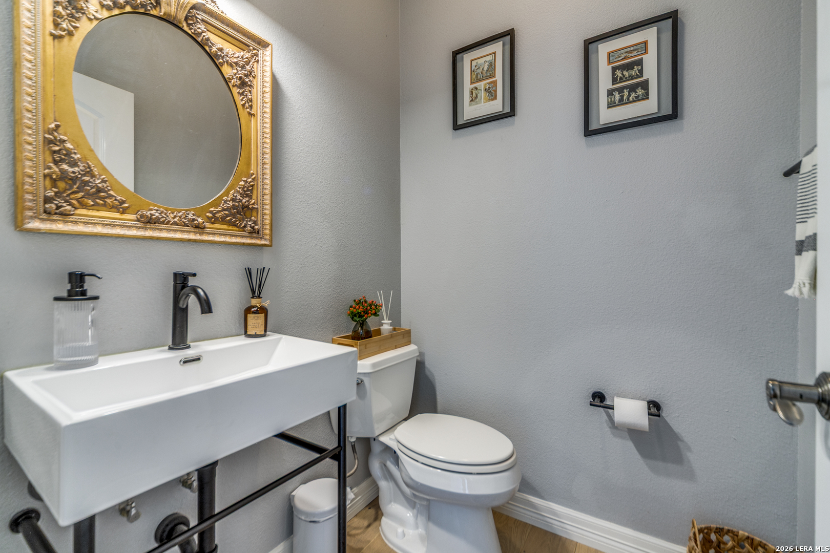 643 Ridge San Antonio, TX 78258 - Photo 27 of 45 a bathroom with a toilet a sink and mirror