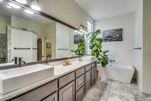 a bathroom with a double vanity sink and a bathtub