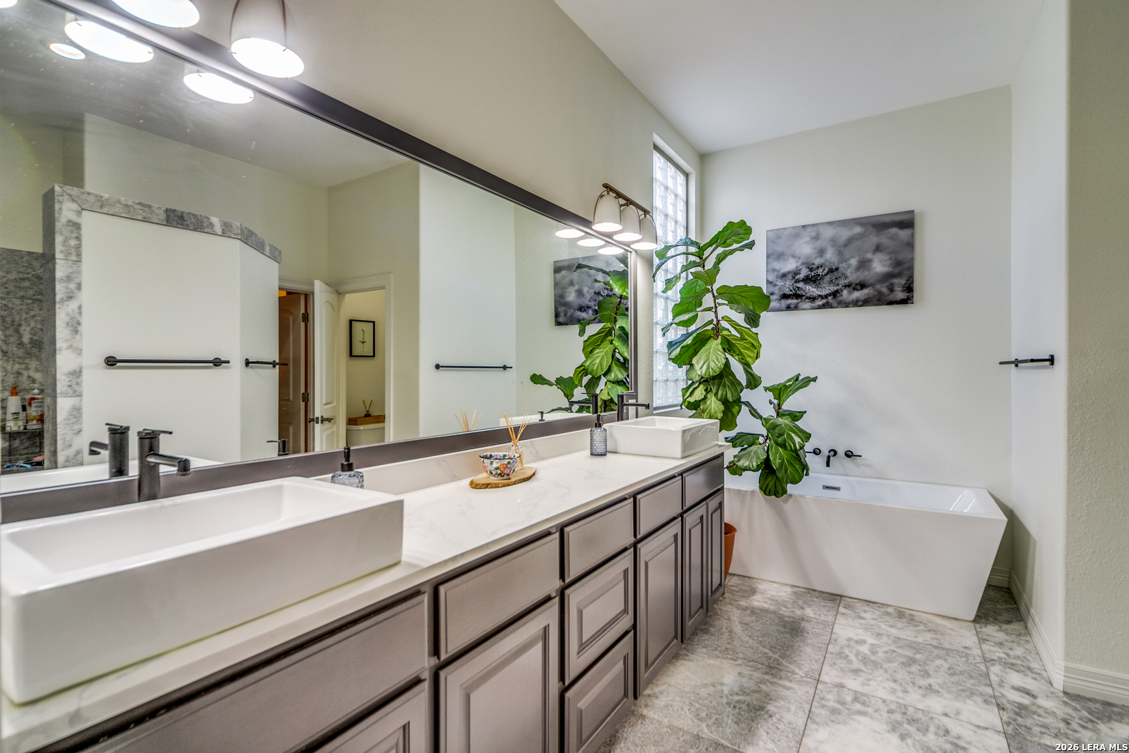 643 Ridge San Antonio, TX 78258 - Photo 30 of 45 a bathroom with a double vanity sink and a bathtub