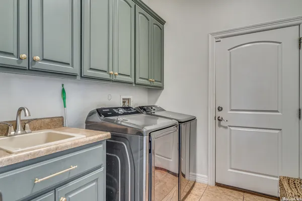 a view of a kitchen with sink and cabinets