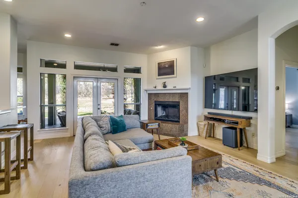 a living room with furniture flat screen tv and a fireplace