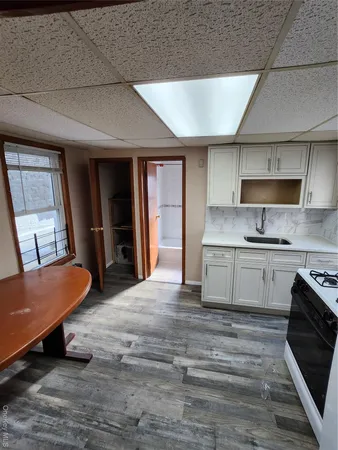 a large kitchen with stainless steel appliances kitchen island granite countertop a refrigerator and a stove