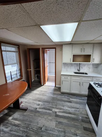 a large kitchen with stainless steel appliances kitchen island granite countertop a refrigerator and a stove