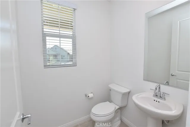 an empty room with a ceiling fan and a window