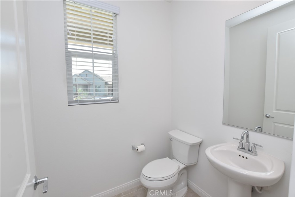 39824 Ninebark Court Temecula, CA 92591 - Photo 13 of 32 a bathroom with a toilet sink and mirror