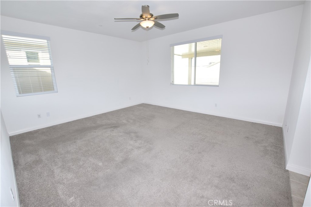 39824 Ninebark Court Temecula, CA 92591 - Photo 14 of 32 an empty room with windows and fan