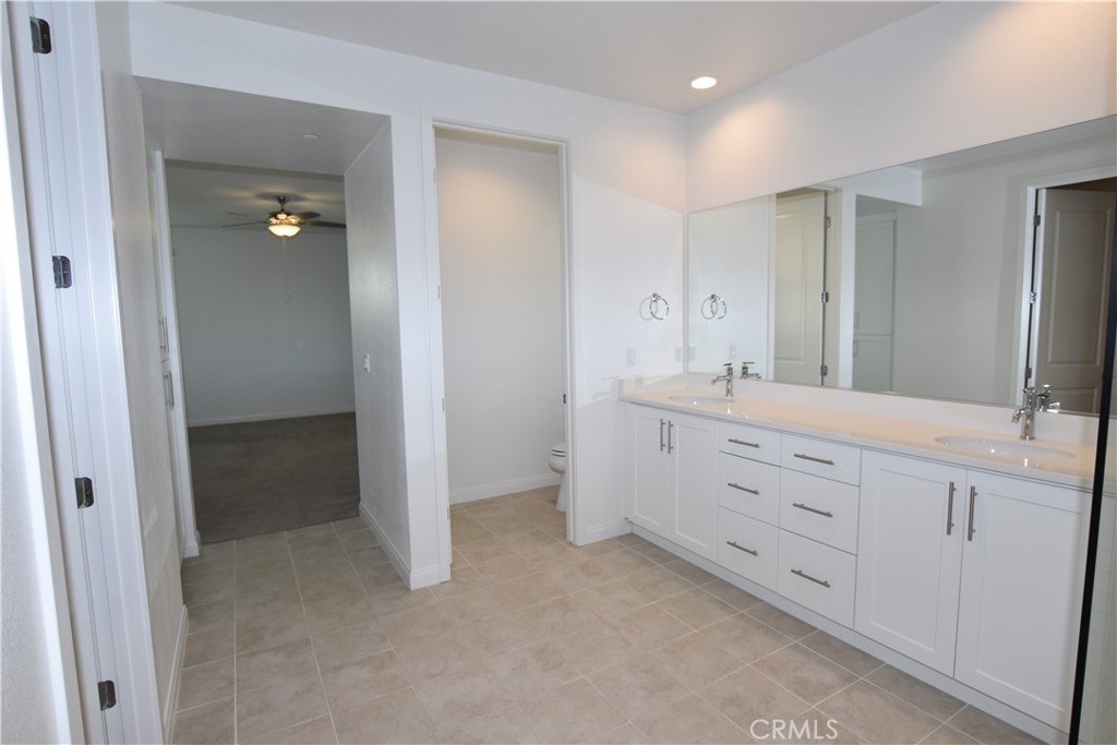 39824 Ninebark Court Temecula, CA 92591 - Photo 17 of 32 a bathroom with a double vanity sink and mirror