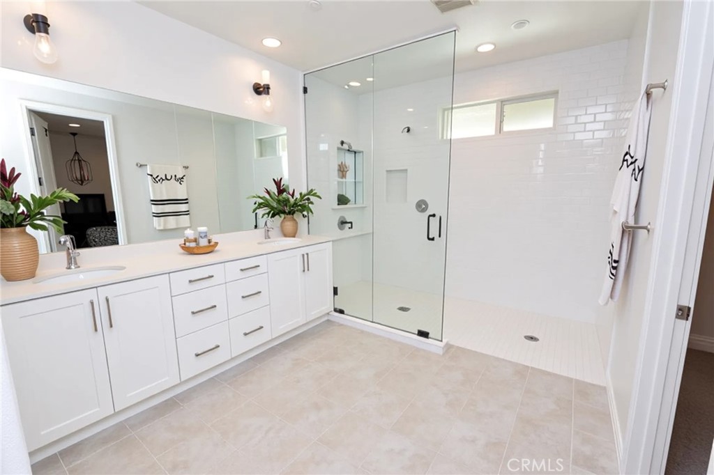 39824 Ninebark Court Temecula, CA 92591 - Photo 6 of 32 a spacious bathroom with a granite countertop sink mirror and shower