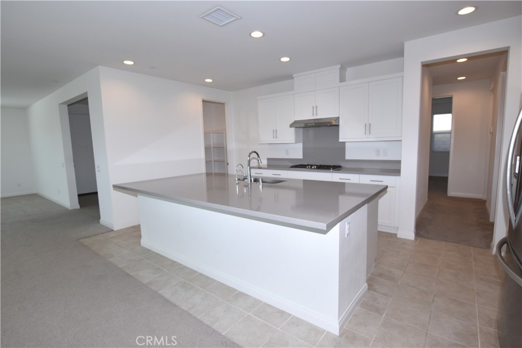 39824 Ninebark Court Temecula, CA 92591 - Photo 7 of 32 a large kitchen with stainless steel appliances granite countertop a sink and a refrigerator