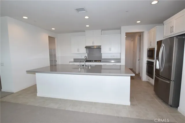 a kitchen with a sink a stove and cabinets