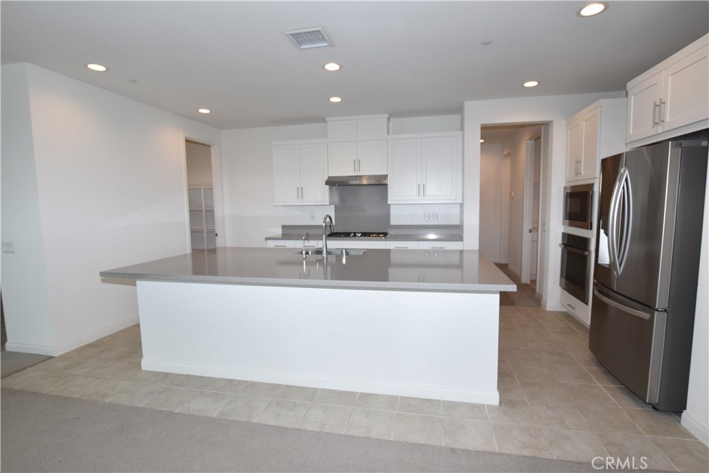 39824 Ninebark Court Temecula, CA 92591 - Photo 8 of 32 a large kitchen with stainless steel appliances granite countertop a large counter top