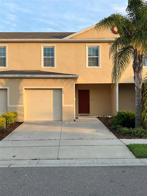 367 Arbor Lakes Drive Davenport, FL 33896 - Photo 1 of 27 a front view of a house with a yard and garage