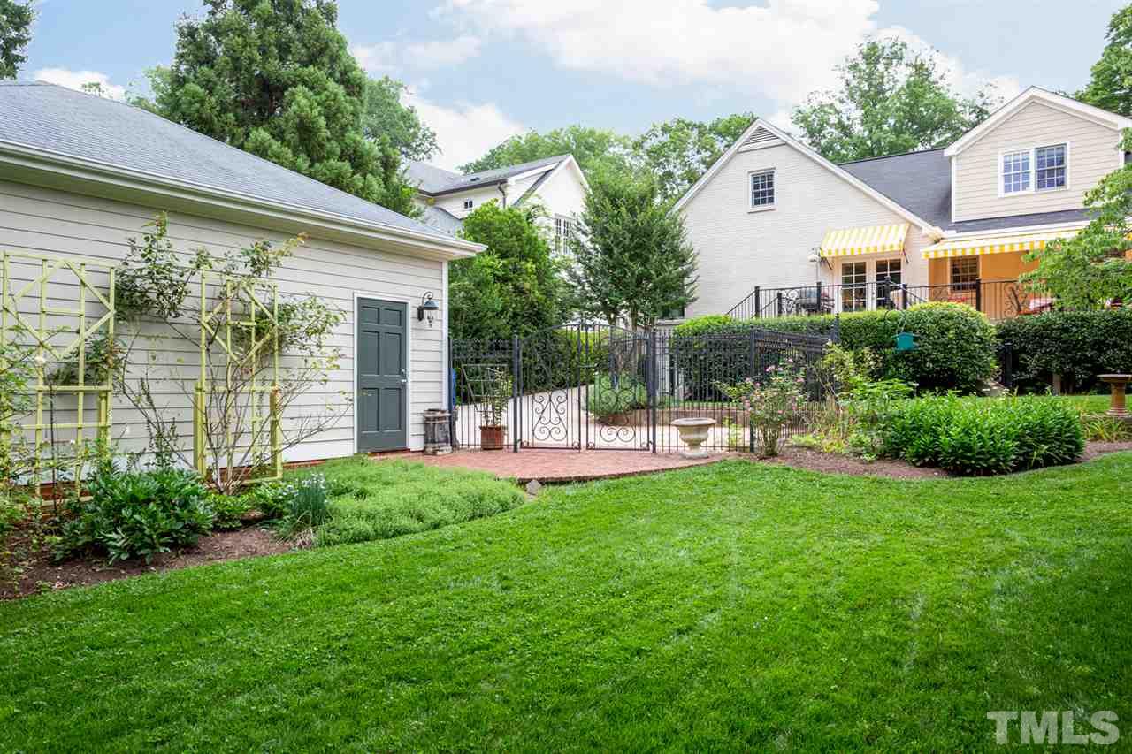 1321 Brooks Avenue Raleigh, NC 27607 - Photo 9 of 30 Oversized garage with lots of storage and adjacent to the spacious back yard fenced in with beautiful 6' wrought iron fencing that develops a patina with age.