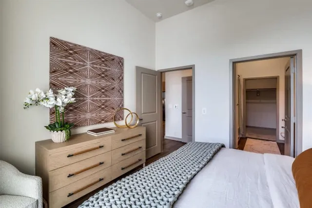 a bedroom with a bed and a dresser