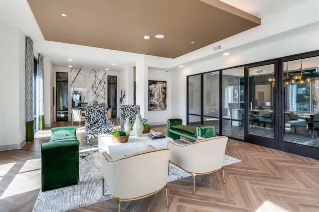 a living room with furniture potted plant and a large window