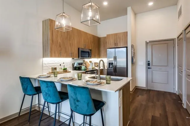 a kitchen with a dining table and chairs