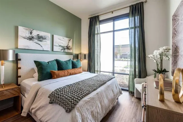 a bedroom with a large bed and a large window