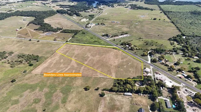 a view of a big yard with lots of windows and entertaining space