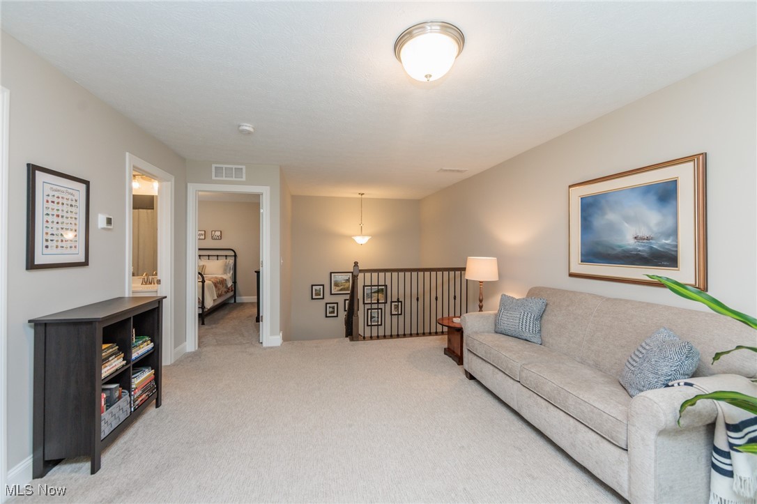 2041 Jaycox Road Avon, OH 44011 - Photo 41 of 50 Living room with carpet floors and baseboards