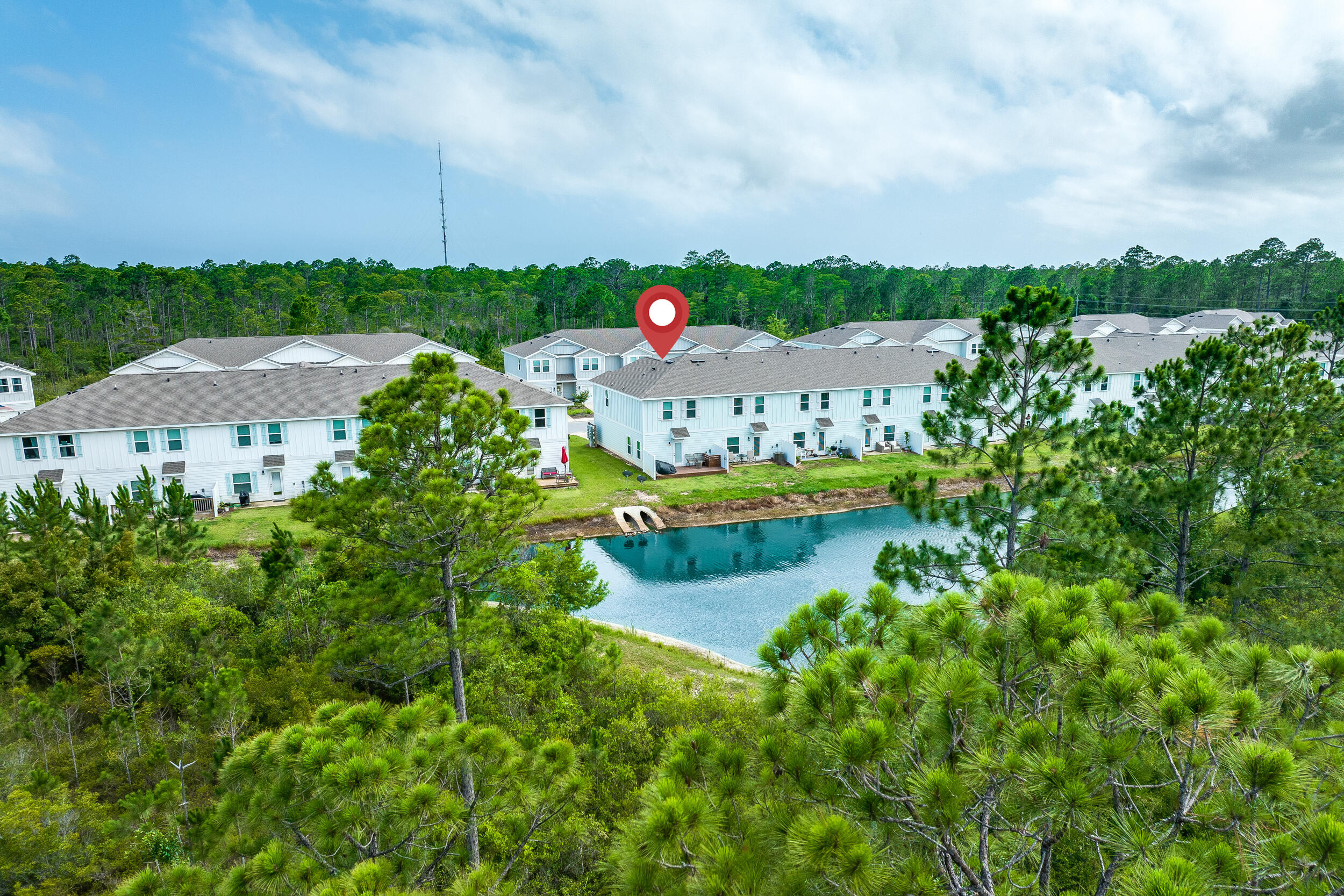 89 Crossing Lane, Unit F Santa Rosa Beach, FL 32459 - Photo 1 of 37 an aerial view of a house with a garden and lake view