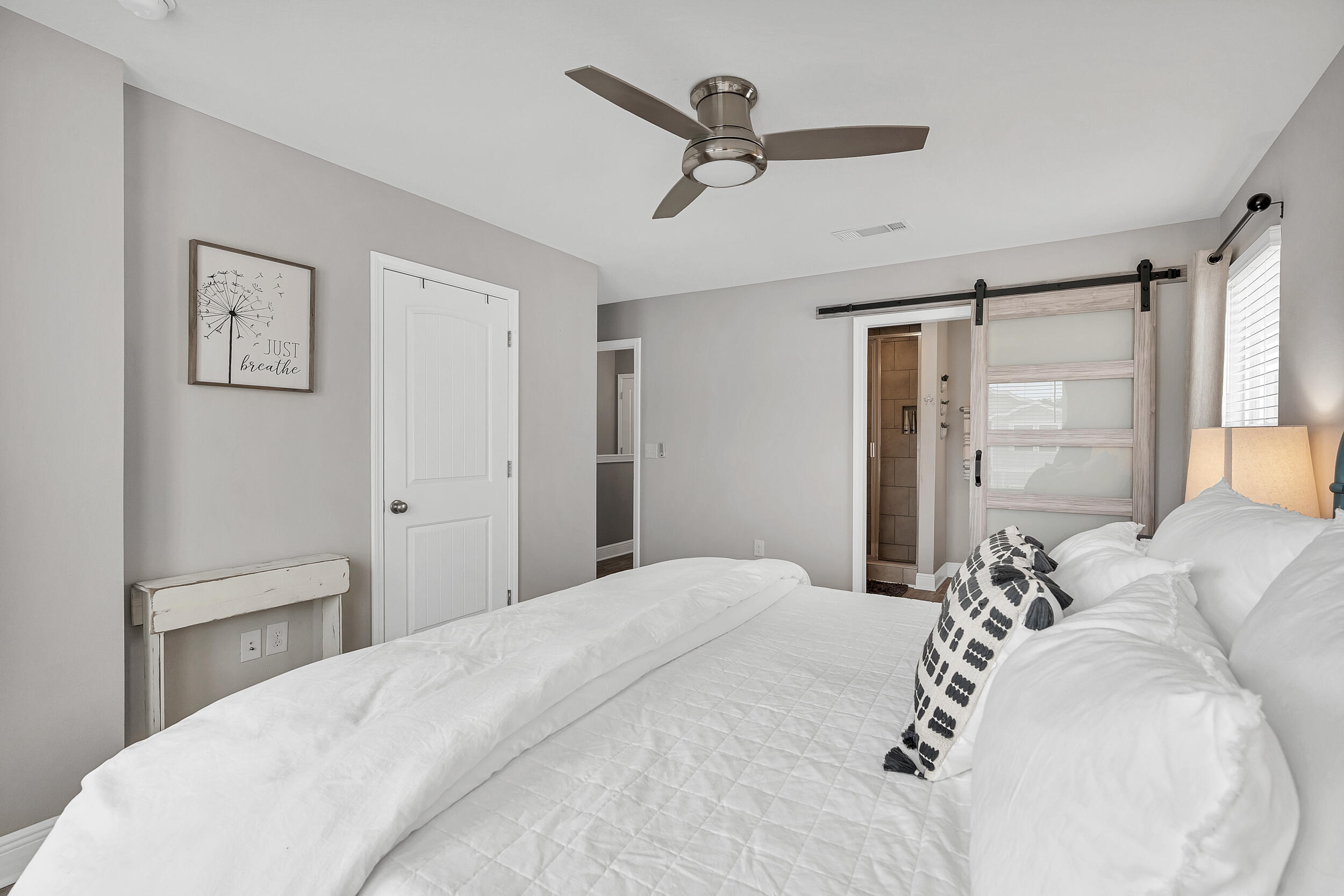 89 Crossing Lane, Unit F Santa Rosa Beach, FL 32459 - Photo 18 of 37 a bedroom with a large bed and a chandelier