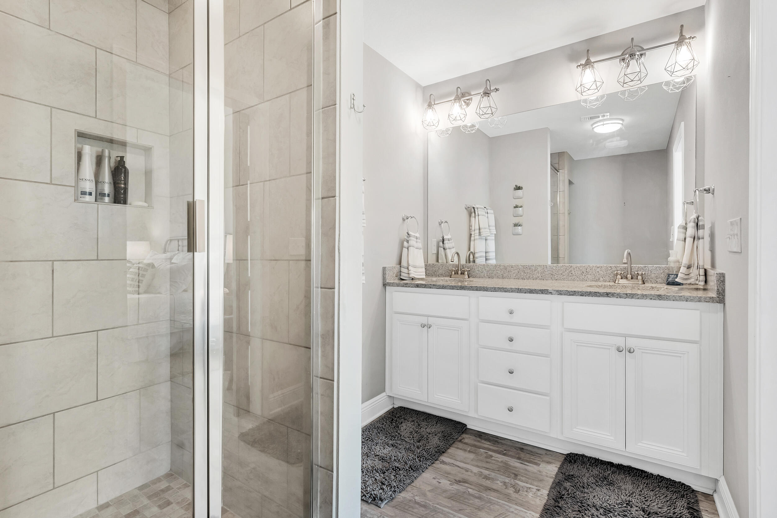 89 Crossing Lane, Unit F Santa Rosa Beach, FL 32459 - Photo 20 of 37 a bathroom with a granite countertop double vanity and a mirror