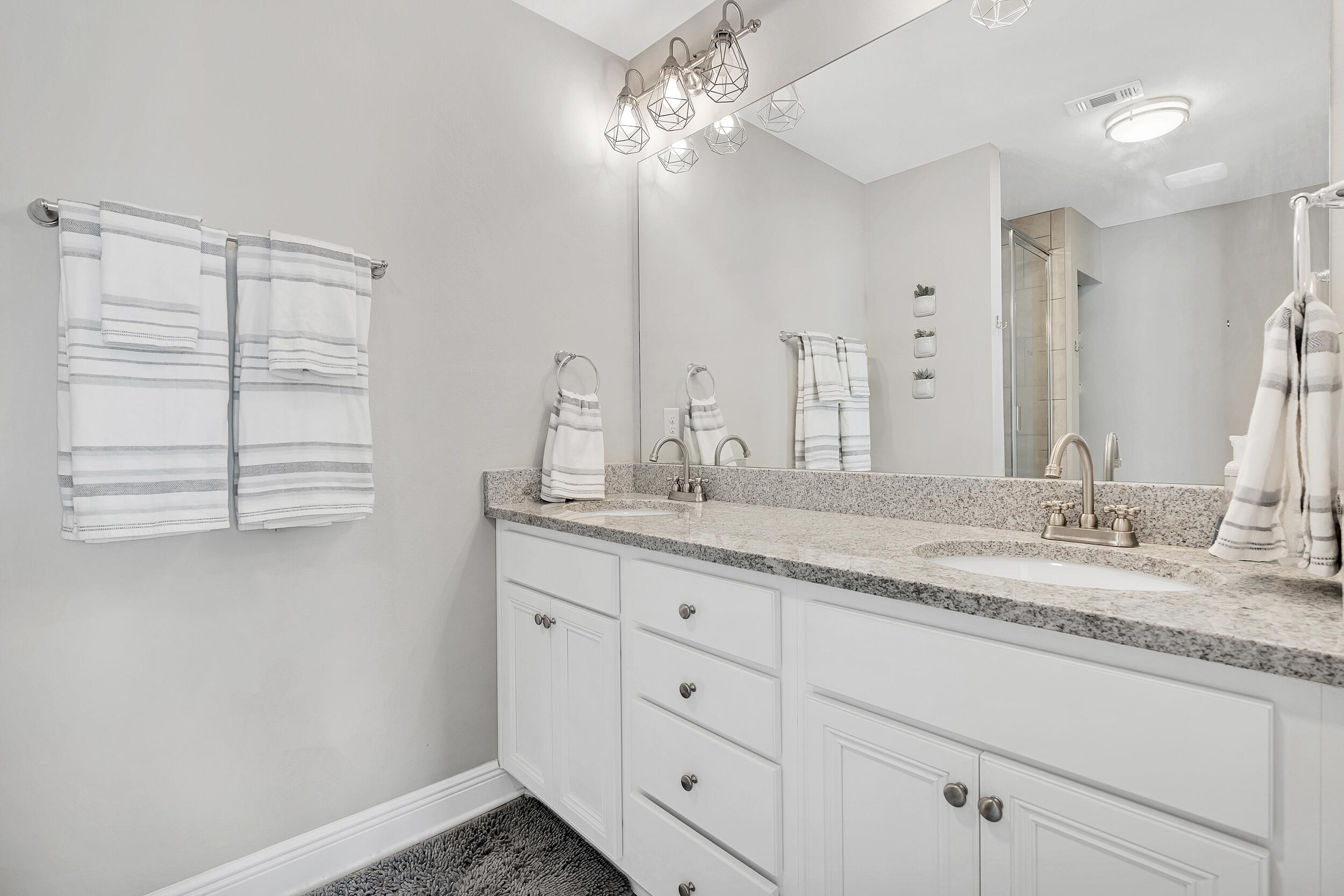 89 Crossing Lane, Unit F Santa Rosa Beach, FL 32459 - Photo 21 of 37 a bathroom with a granite countertop sink and a mirror