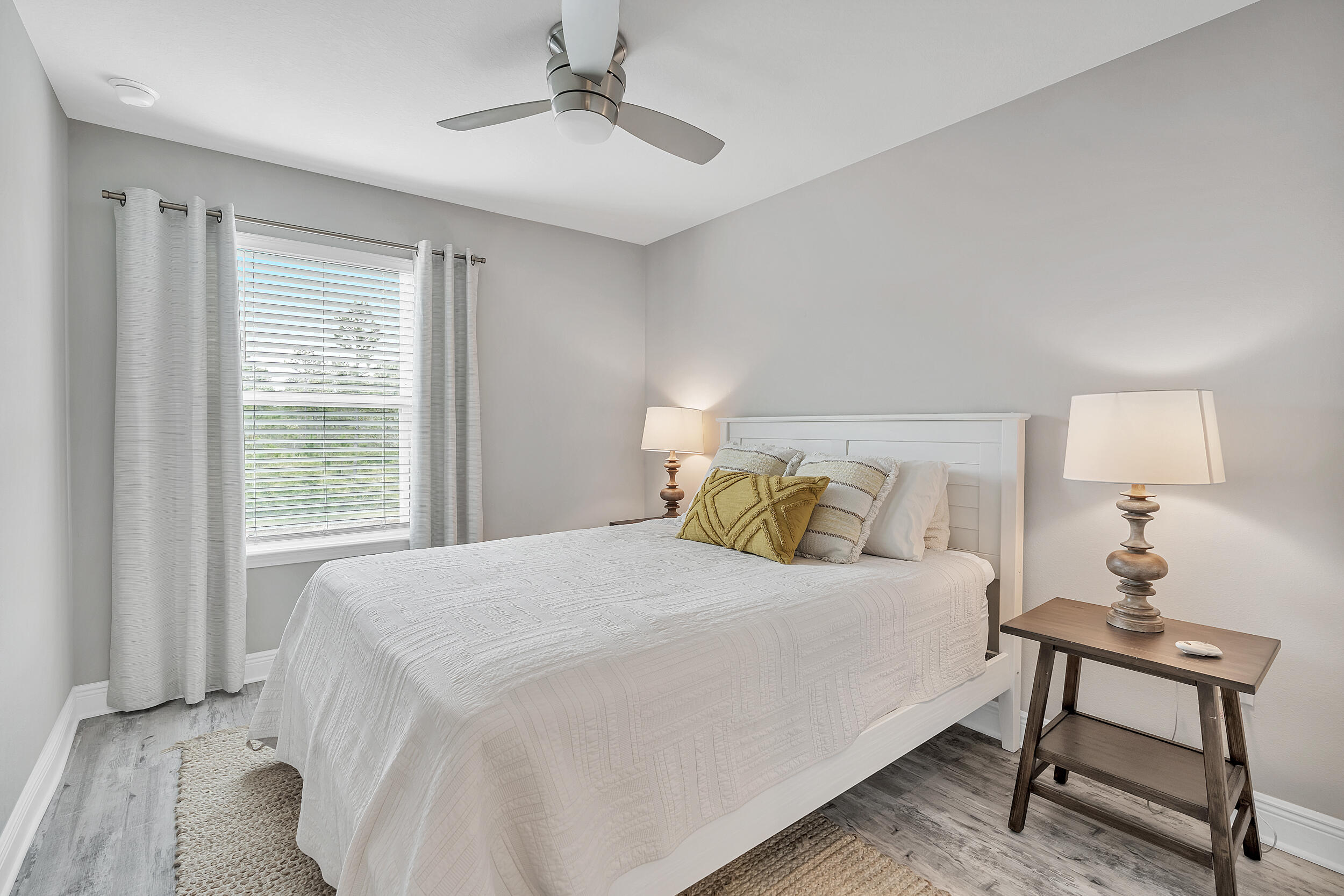 89 Crossing Lane, Unit F Santa Rosa Beach, FL 32459 - Photo 22 of 37 a bedroom with a bed and a lamp on table