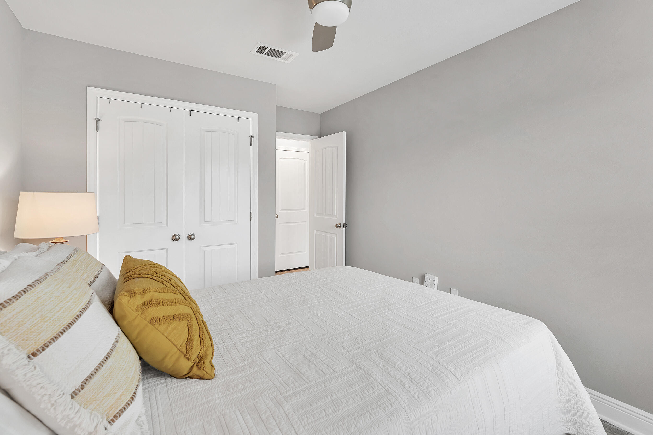 89 Crossing Lane, Unit F Santa Rosa Beach, FL 32459 - Photo 23 of 37 a bedroom with a bed and painting on the wall