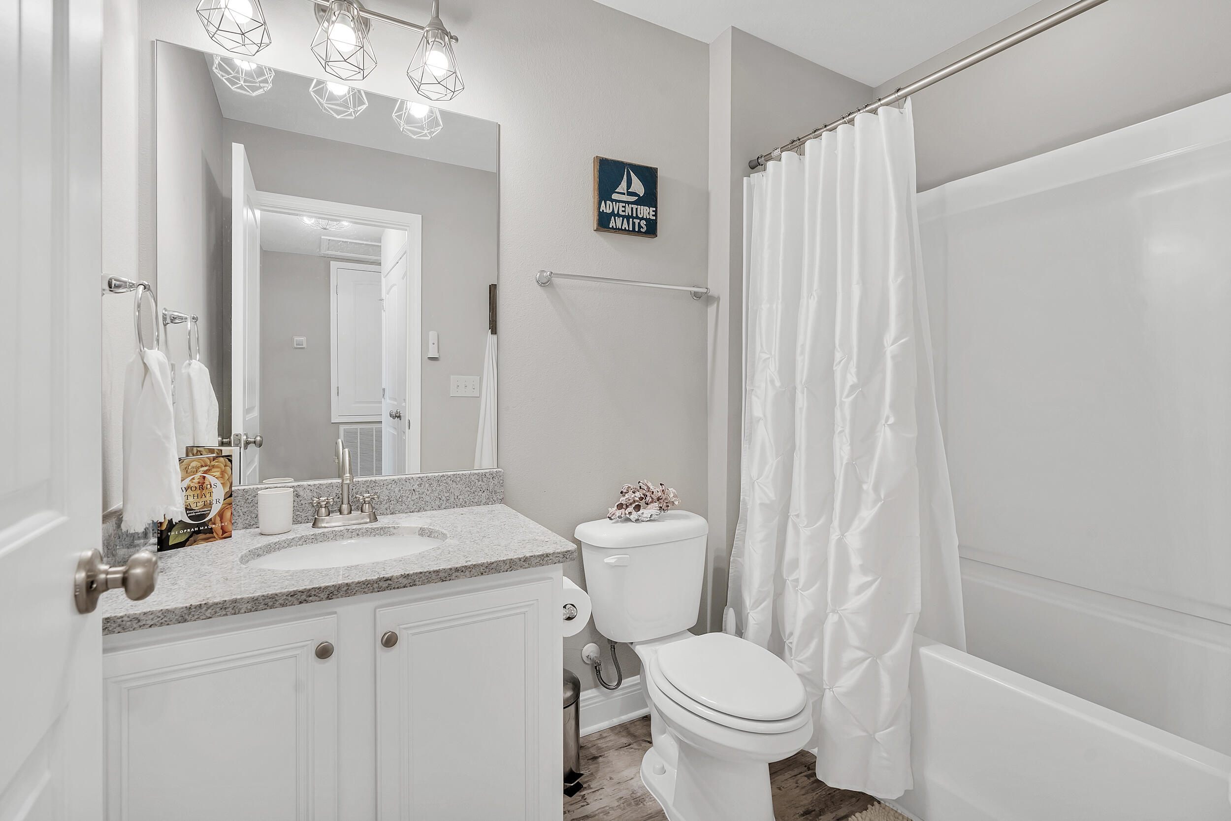 89 Crossing Lane, Unit F Santa Rosa Beach, FL 32459 - Photo 26 of 37 a bathroom with a granite countertop sink toilet and a mirror