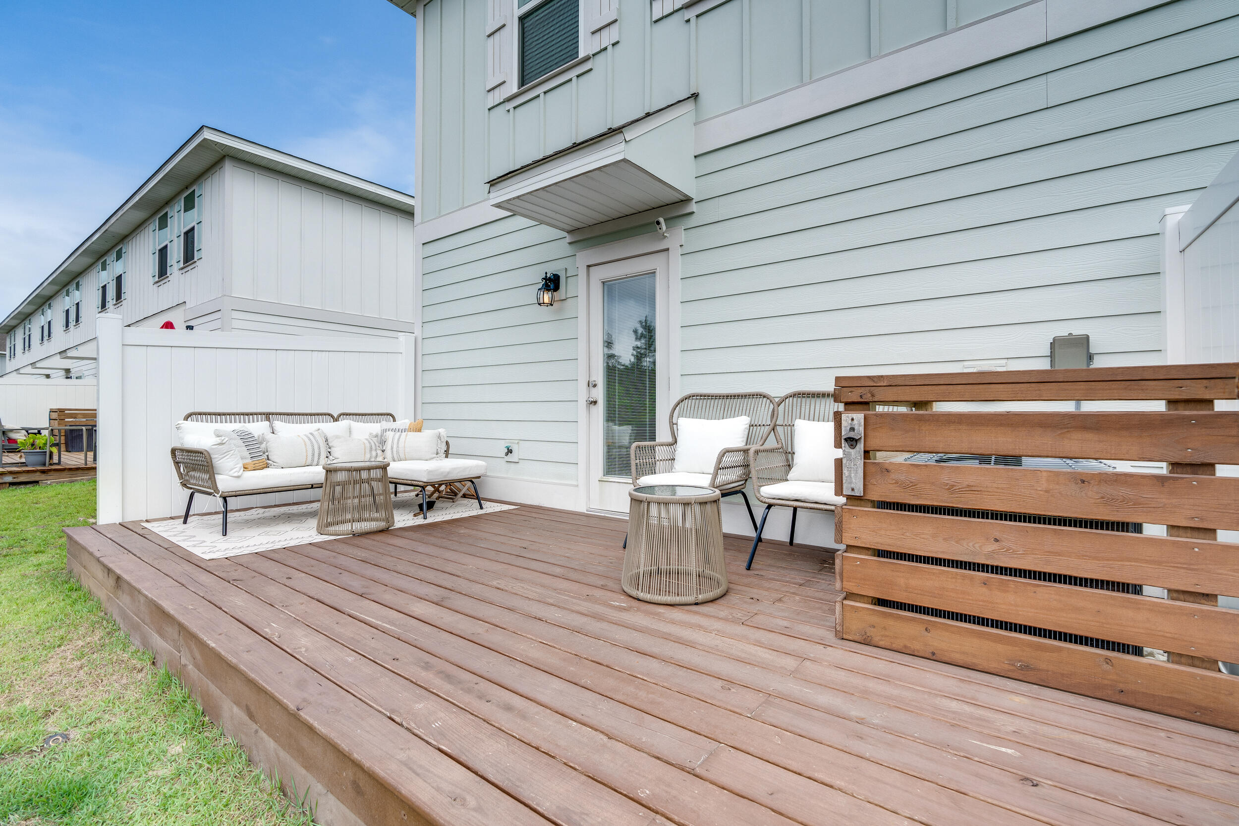 89 Crossing Lane, Unit F Santa Rosa Beach, FL 32459 - Photo 30 of 37 a view of a patio with table and chairs and wooden floor