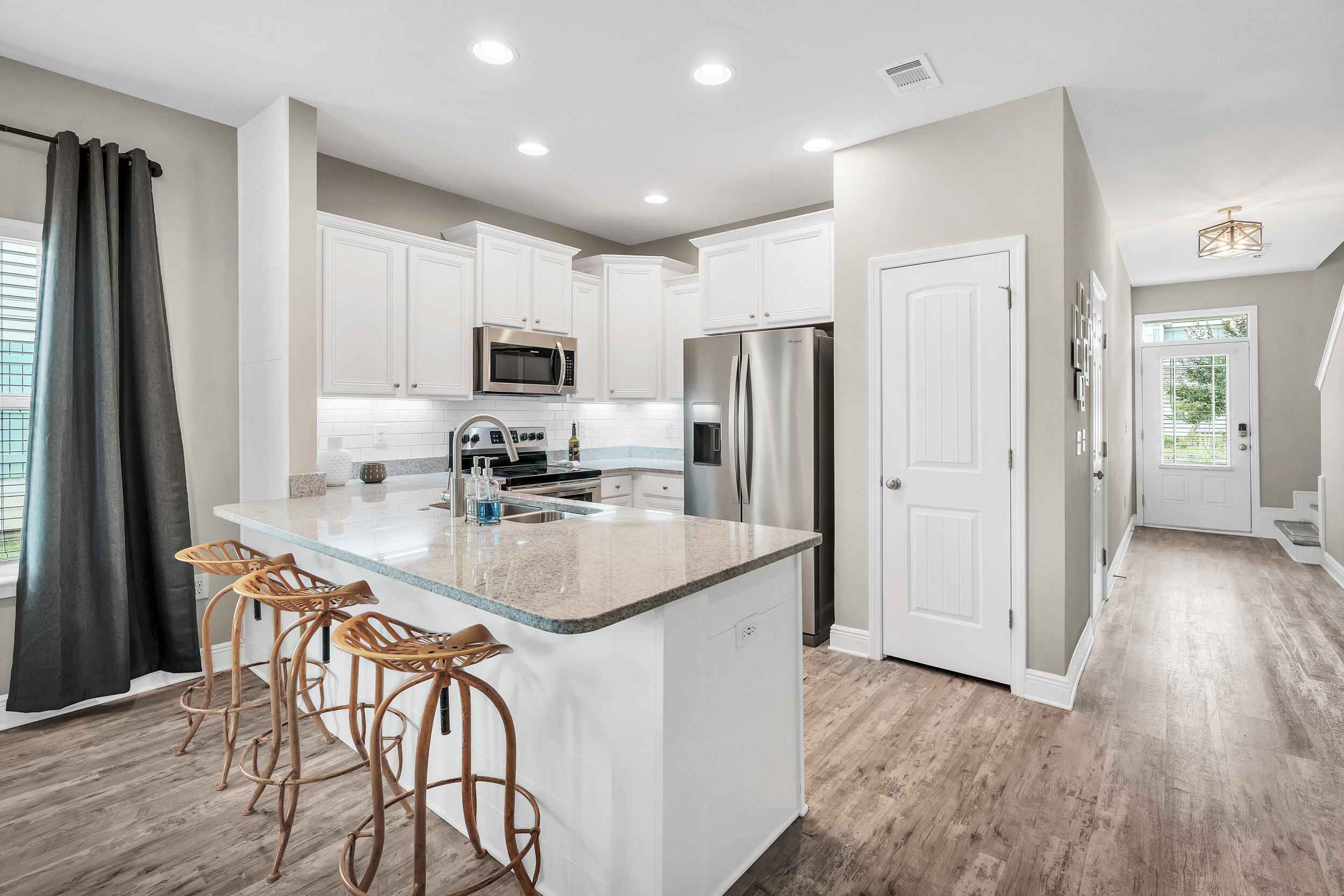 89 Crossing Lane, Unit F Santa Rosa Beach, FL 32459 - Photo 10 of 37 a kitchen with stainless steel appliances a refrigerator stove microwave and cabinets