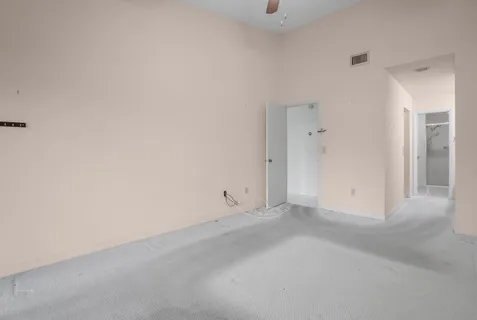 a view of walk in closet with empty racks