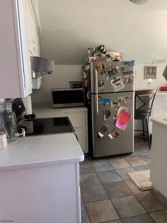 a kitchen with furniture a sink and a stove top oven