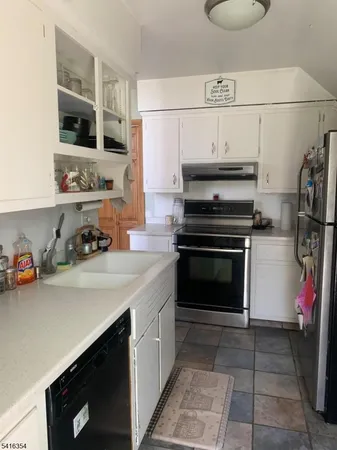 a kitchen with a sink cabinets and appliances
