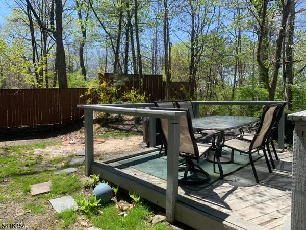 a view of balcony with two chairs and a table