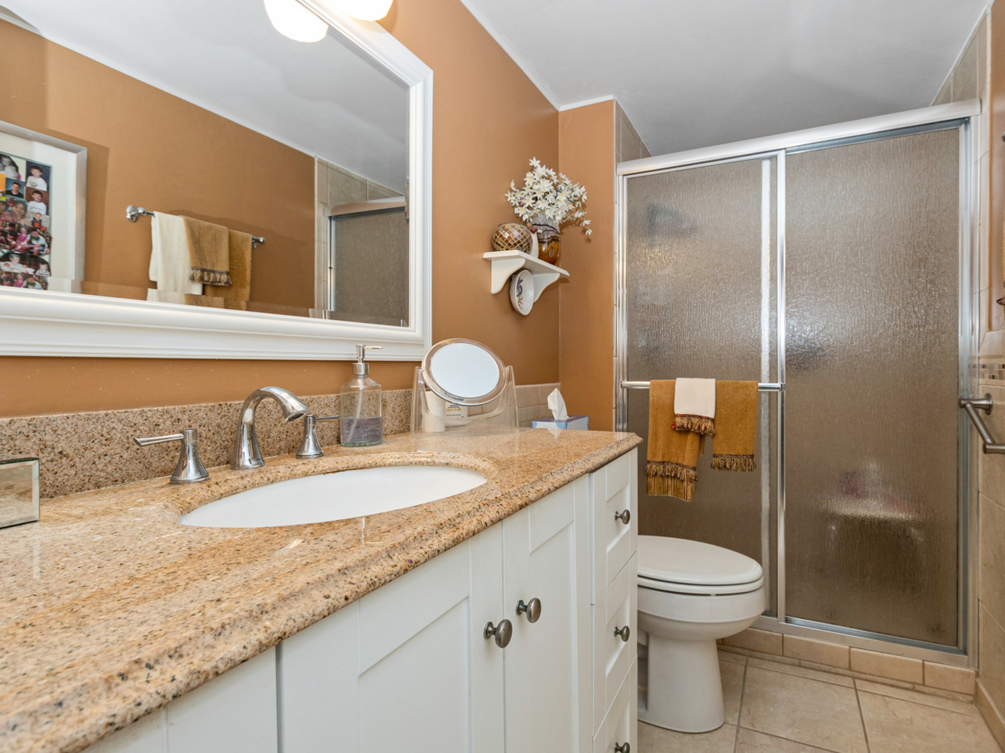 11136 NW Road, Unit D Palos Hills, IL 60465 - Photo 18 of 23 a bathroom with a granite countertop sink a toilet and shower