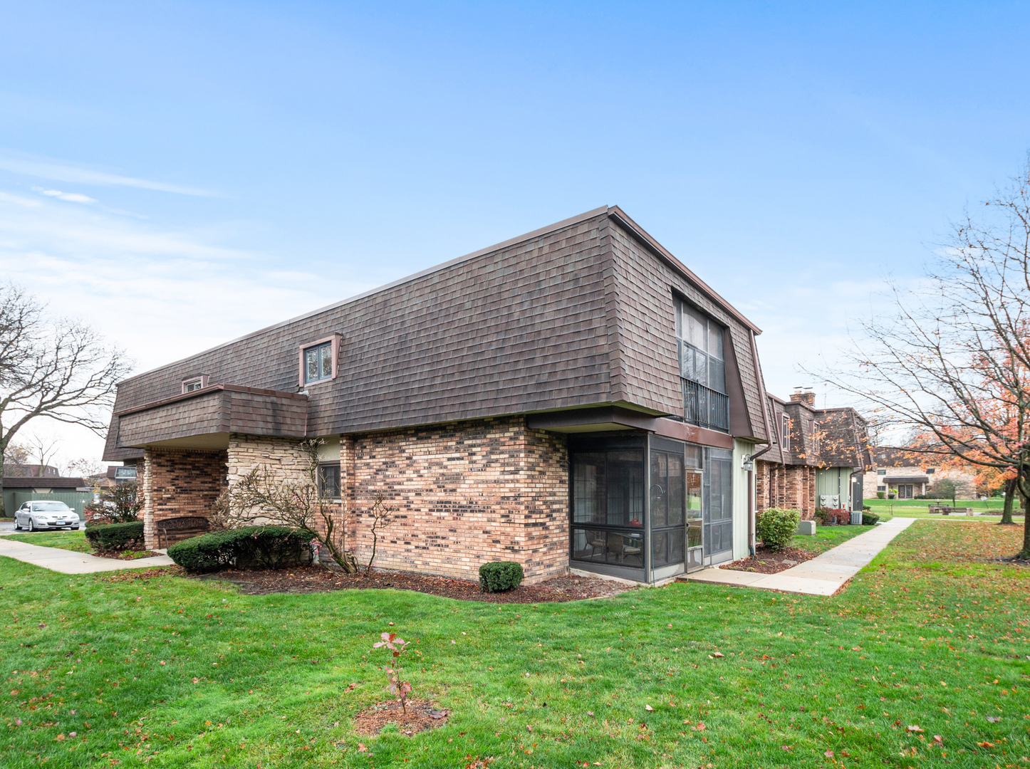 11136 NW Road, Unit D Palos Hills, IL 60465 - Photo 2 of 23 a front view of a house with a garden and yard