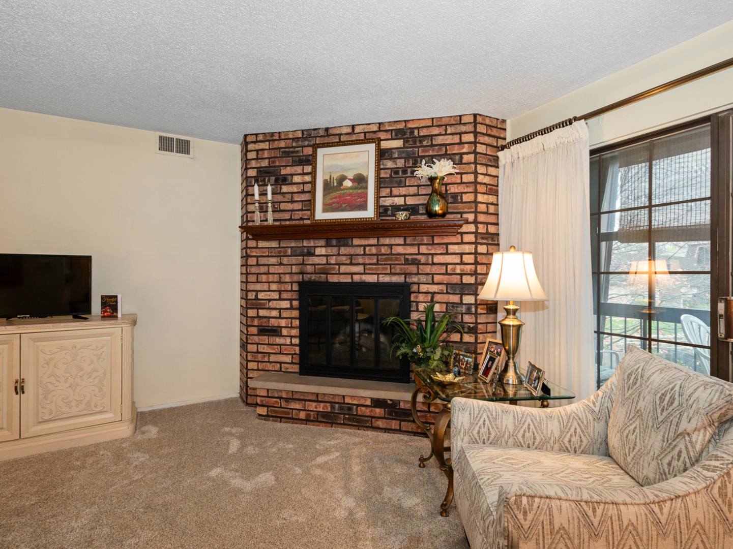 11136 NW Road, Unit D Palos Hills, IL 60465 - Photo 8 of 23 a living room with furniture a flat screen tv and a fireplace