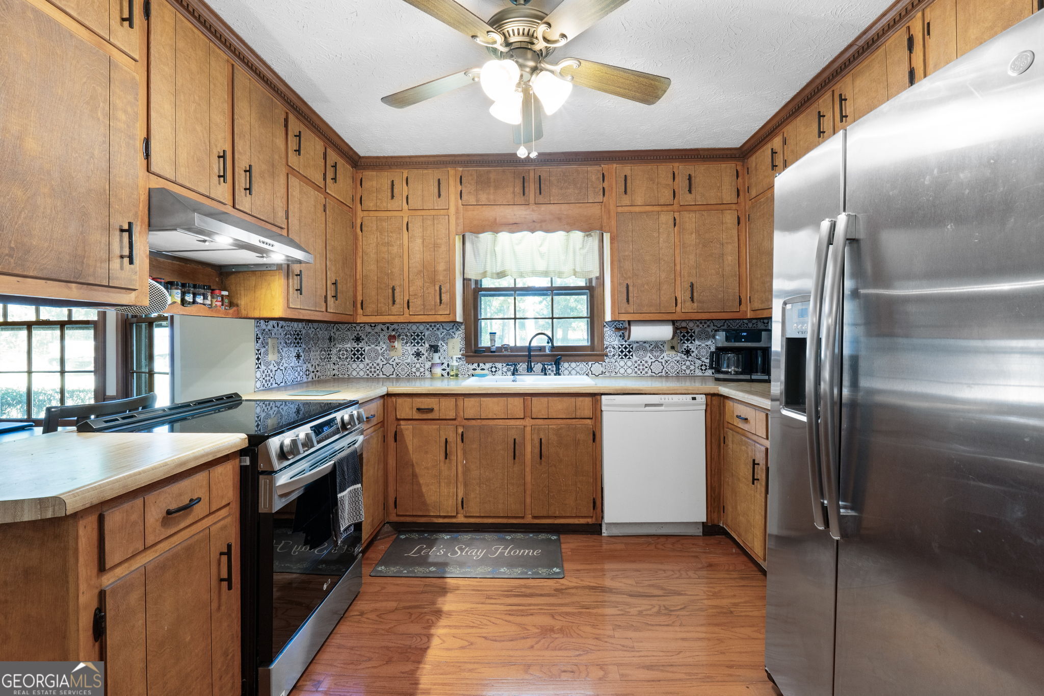 5162 Kurt Lane Southwest Conyers, GA 30094 - Photo 11 of 37 a kitchen with stainless steel appliances granite countertop a sink a stove and a refrigerator