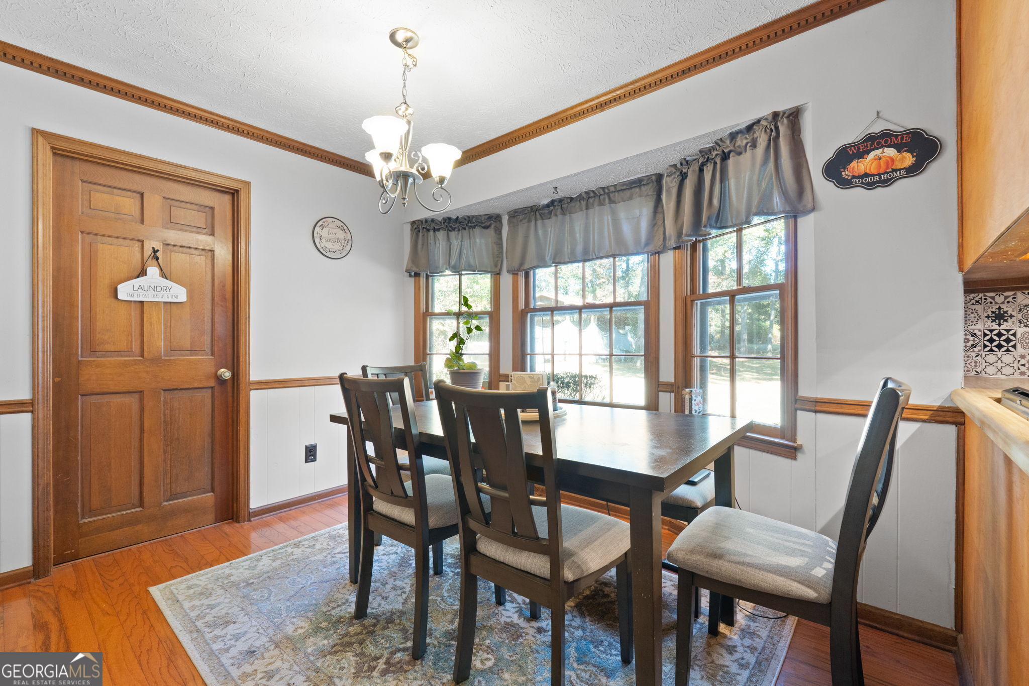 5162 Kurt Lane Southwest Conyers, GA 30094 - Photo 14 of 37 a view of a dining room with furniture window and wooden floor