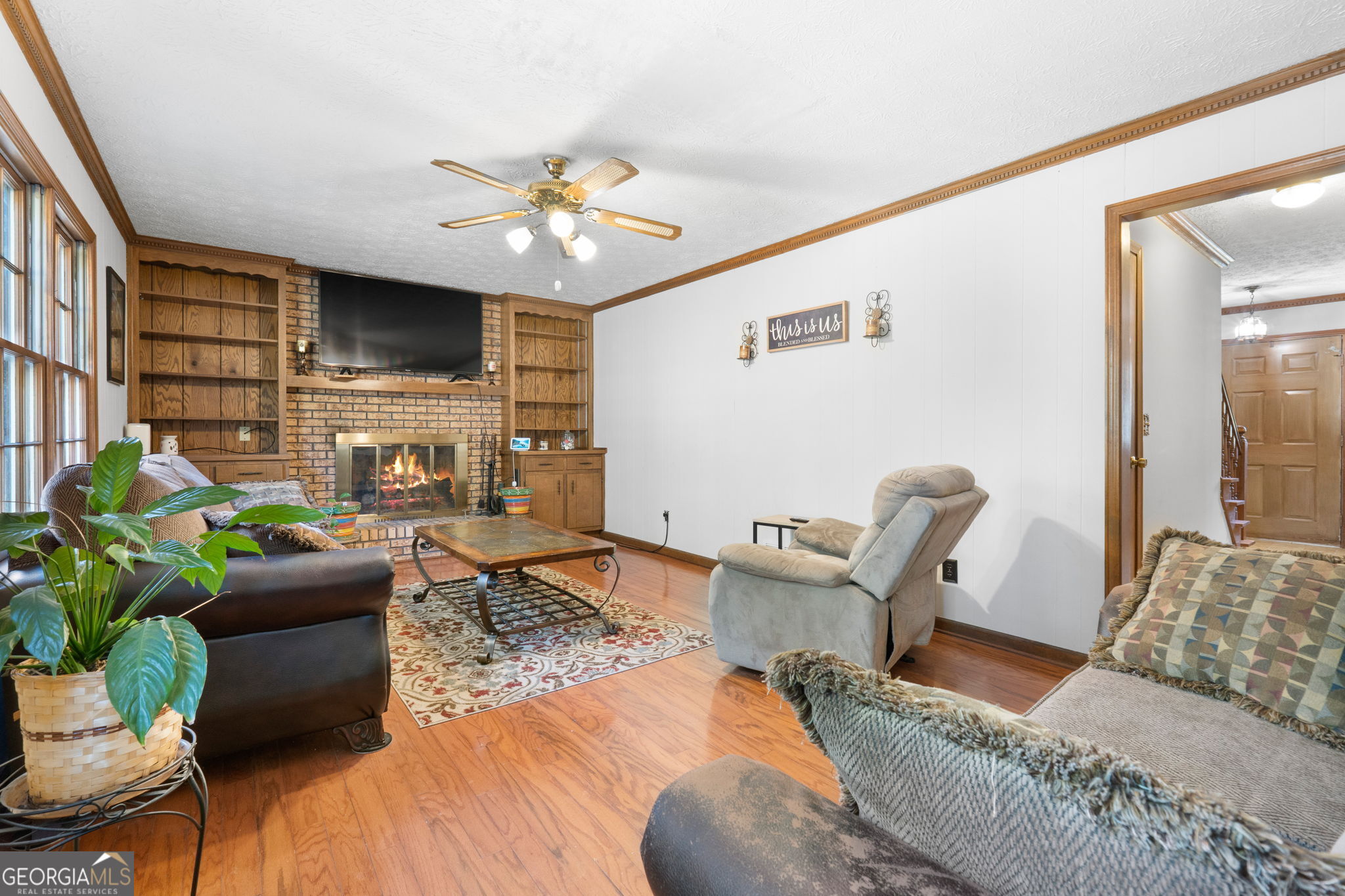 5162 Kurt Lane Southwest Conyers, GA 30094 - Photo 19 of 37 a living room with furniture a chandelier and a flat screen tv