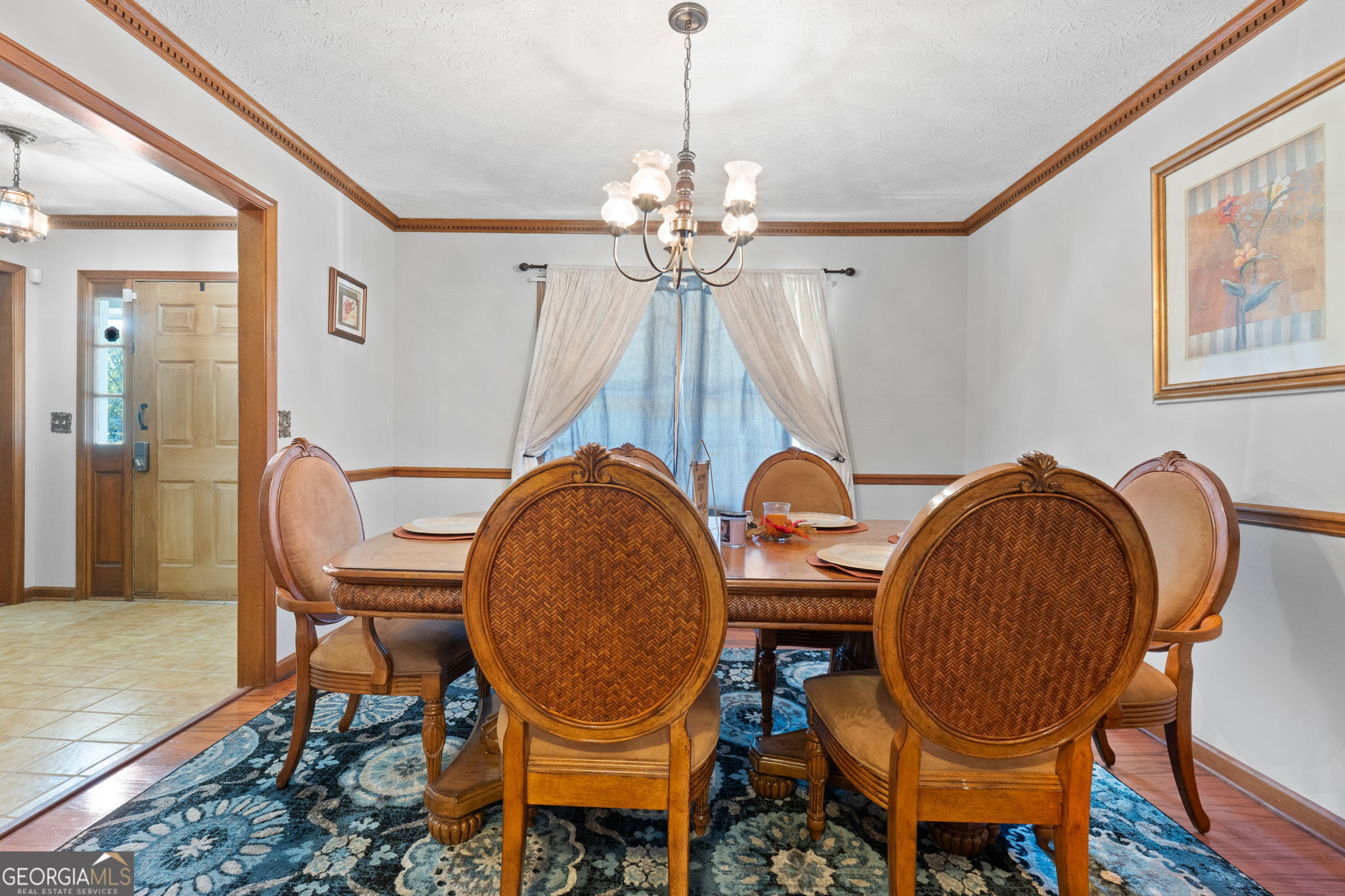 5162 Kurt Lane Southwest Conyers, GA 30094 - Photo 9 of 37 a dining room with furniture a chandelier and wooden floor